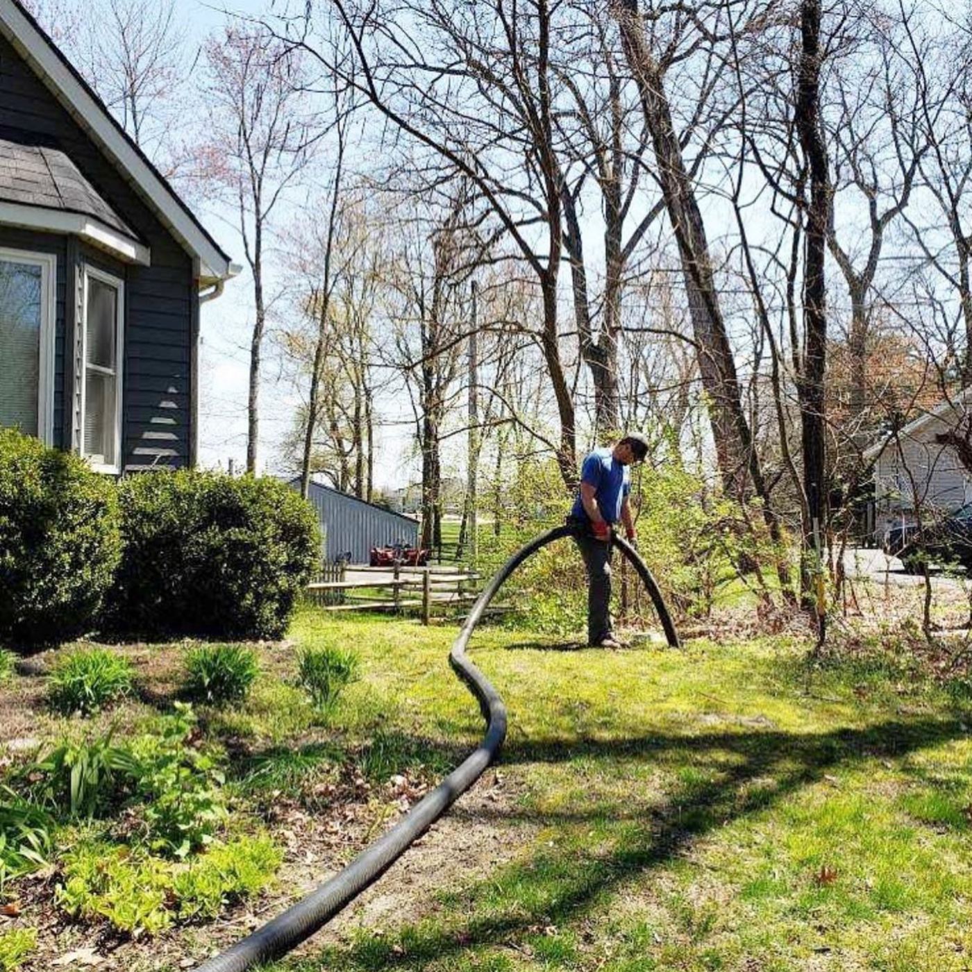 Technician pumping a residential septic tank