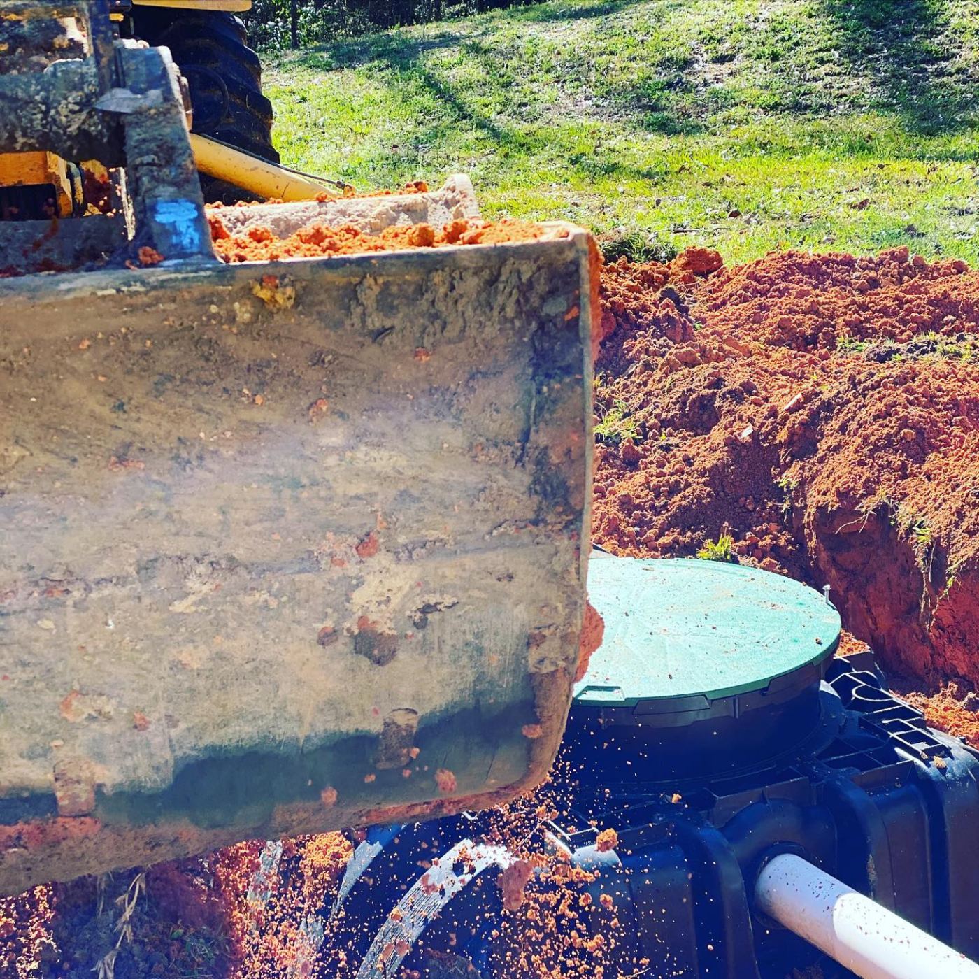 New septic tank being set with an excavator
