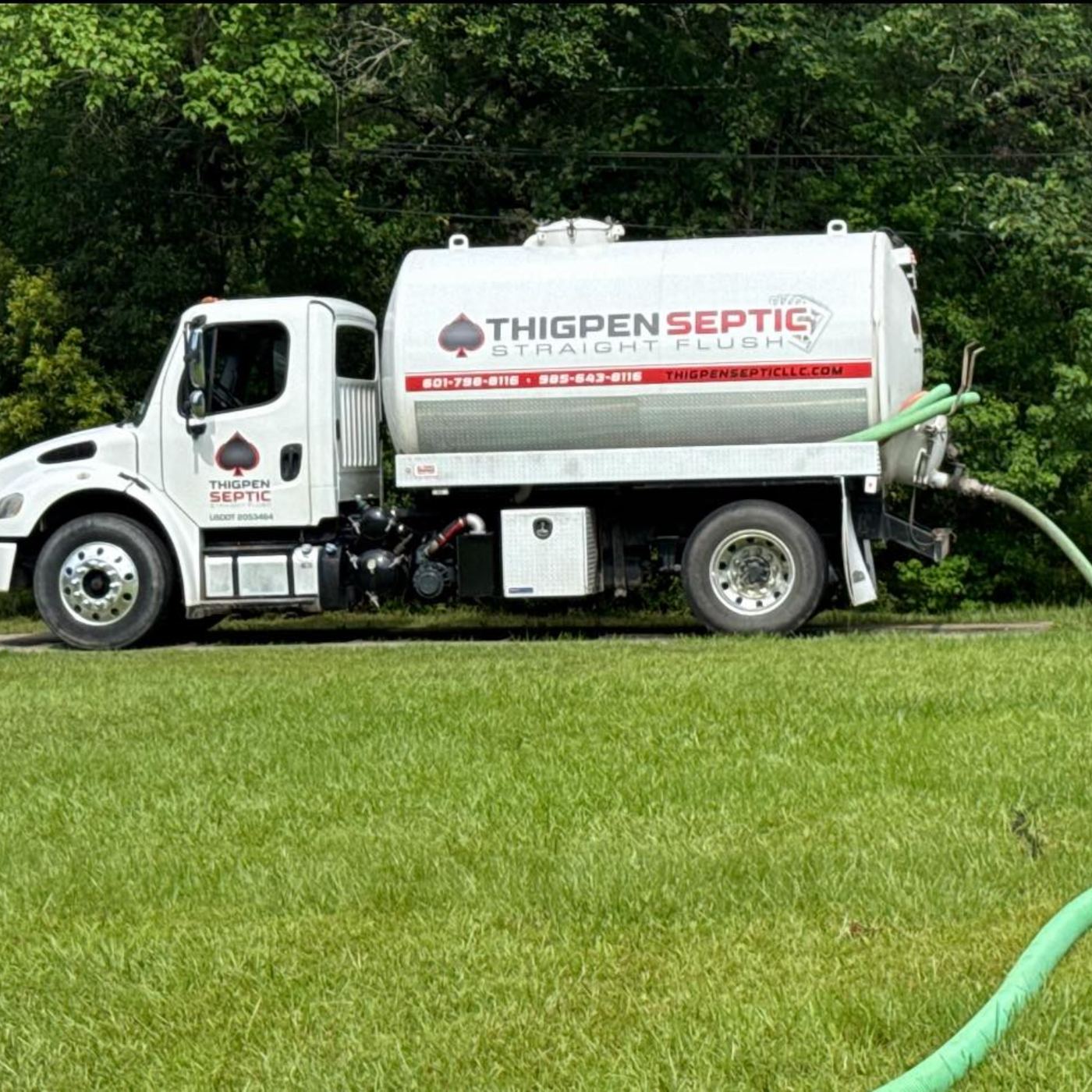 Thigpen Septic pump truck parked on a green lawn